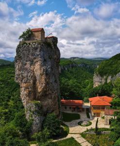 a house perched on top of a rock at Butichi Guest House in Chiatʼura