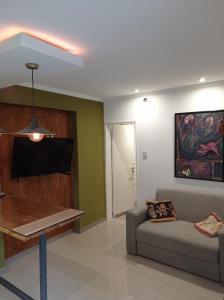 a living room with a couch and a flat screen tv at Buona Notte! in Bahía Blanca