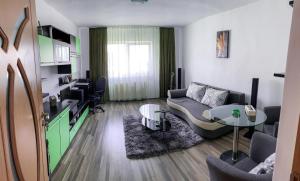 a living room with a couch and a table at Apartament Zarnesti „Saturn” in Zărneşti