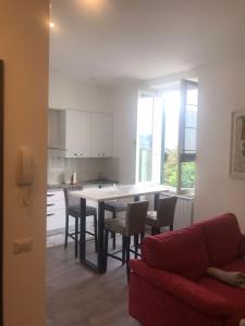 a kitchen and dining room with a table and chairs at La maison du Mira in Intra