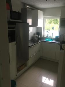 a kitchen with a stainless steel refrigerator and a window at Apartment in Reutlingen