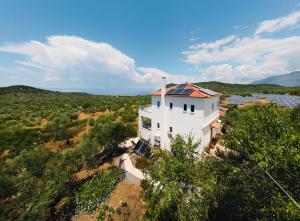 an aerial view of a white house in a field at Appartement in OLIVE GROOVE HOUSE PELOPONNESOS WESTERN MANI in Kalianeika
