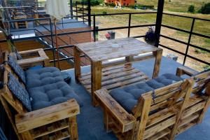 a wooden table and chairs on a patio at къщички Поляните in Sinemorets