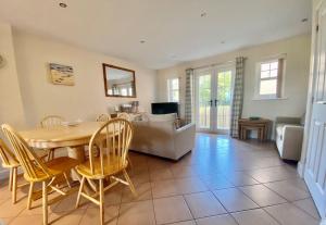 a living room with a table and chairs and a couch at Cladach in Garlieston