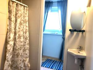 een badkamer met een douchegordijn en een wastafel bij Apartment Viiger in Kärdla