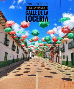 a street with umbrellas hanging over a street at Hostal Bambu in San Agustín