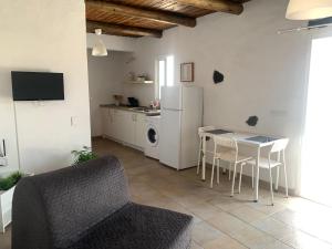 a living room with a table and a kitchen at Apartment in Famara Beach in Teguise