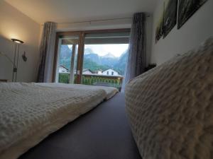 a bedroom with a bed and a window with a view at Loferama Top 1 in Lofer