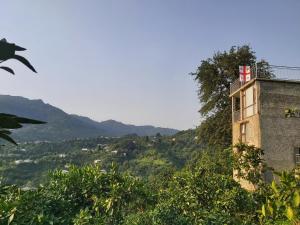 un edificio con una cruz roja a su lado en Mtirala House en Khala