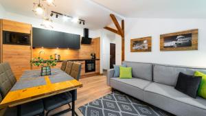 a living room with a couch and a table at Stacja Sniezka in Karpacz
