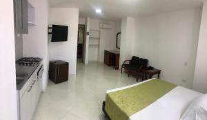 a bedroom with a bed and a kitchen with a stove at Hotel Florida Inn in Medellín