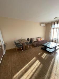 a living room with a couch and a table at Rich-3 SP apartments in Ravda
