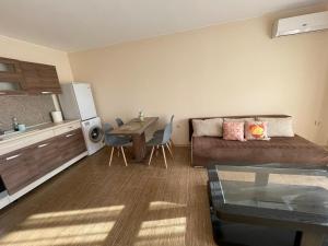a living room with a couch and a table at Rich-3 SP apartments in Ravda