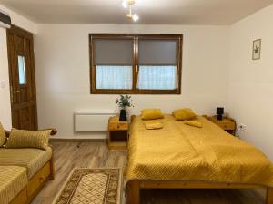 a bedroom with a bed and a couch at Nagymama Vendégháza in Telkibánya +41 photos