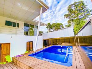 a swimming pool in the backyard of a house at Puerto Viejo Lodge in Puerto Viejo