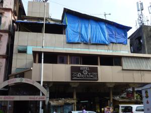 a building with a blue tarp on top of it at Hotel Orient Palace in Mumbai