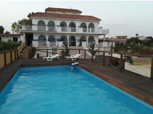 a large swimming pool in front of a house at Donna Maria in Cava D'aliga