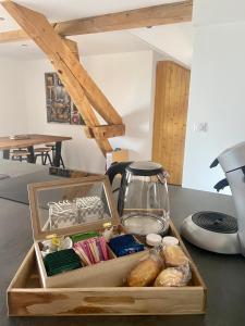 a wooden box filled with items on a table at BORD DE LAC,2 chambres SUPERBE VUE LAC 5mn Evian in Lugrin +9 photos