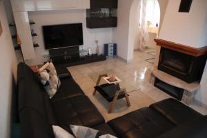 a living room with a couch and a fireplace at Kroatien Villa Merćepi in Katuni
