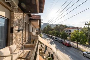 an apartment balcony with a view of a street at LYDIA suites and rooms in Litochoro