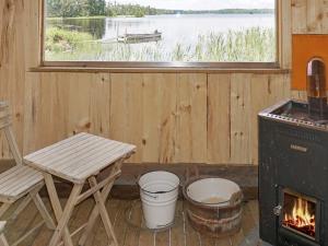 a room with a bench and a stove and a window at 4 person holiday home in N SSJ in Nässjö