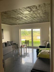 a living room with a couch and a table and chairs at Zielony Daszek in Sianozety