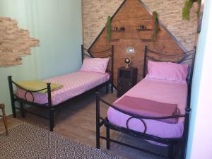 A bed or beds in a room at Stanza Del Viggiatore