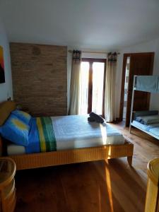 a bedroom with a large bed and a brick wall at Casale del Sole in Cepagatti