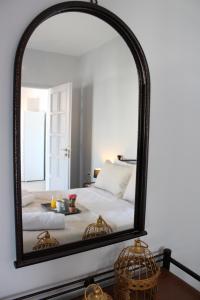 a large mirror reflecting a bed in a bedroom at Harmony Villa Milos in Pollonia