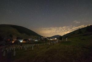 a cemetery at night with a star filled sky at Guesthouse Letnja Basta in Lukomir