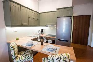 a kitchen with a table with a bottle of wine at Sophie's Apartment 1&2 in Poros