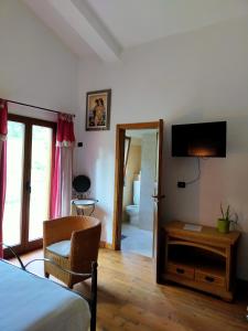 a bedroom with a bed and a desk and a television at Casale del Sole in Cepagatti
