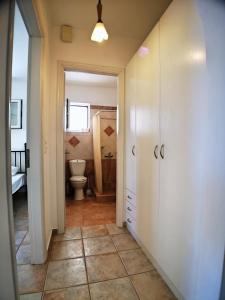 a hallway with a bathroom with a toilet in it at Verandas Sea Houses in Agia Pelagia
