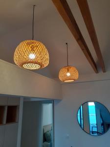 two lights hanging from a ceiling with a mirror at Panorama Apartments in Herceg-Novi +8 photos