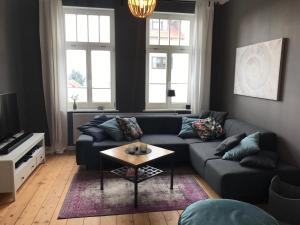 a living room with a couch and a coffee table at Villa Hanne mit Garten in Thale
