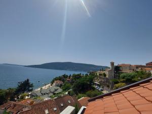 a view of a town and a body of water at Panorama Apartments in Herceg-Novi