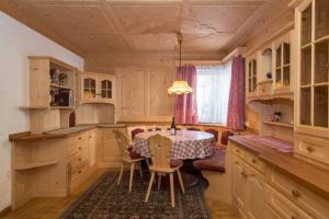 a kitchen with a table and chairs in a room at Chalet Merisana in Selva di Val Gardena