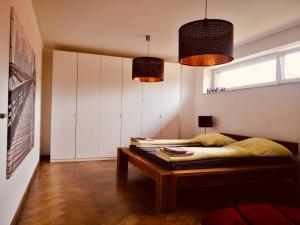 a bedroom with a bed and a table in it at Studio/Loft in Eberswalde in Eberswalde-Finow