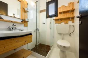 a bathroom with a toilet and a sink and a shower at Ragoussis Sweet Rooms in Naousa