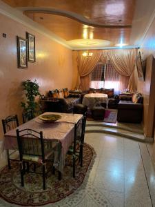 a living room with a table and a couch at Cozy Home in Azrou in Azrou