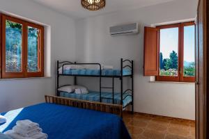 a bedroom with two bunk beds and a window at Villa Duca Country House in Castellammare del Golfo
