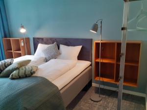 a bed with white sheets and pillows in a room at Eidfjord Adventure hotel Øvre Eidfjord in Eidfjord