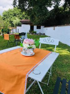 a table with a vase of flowers on it at Villa Alessandra in Maratea