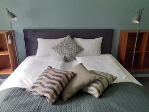 a bed with three pillows on top of it at Eidfjord Adventure hotel Øvre Eidfjord in Eidfjord +12 photos