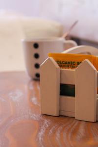 a box of dominoes sitting on a table with a cup at Mistral-Patmos in Patmos