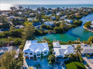 an aerial view of a home with a river at Our Great Escape home in Anna Maria