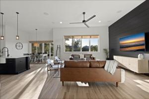 a living room with a brown couch and a kitchen at Our Great Escape home in Anna Maria +54 photos