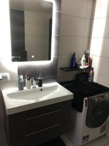 un bagno con un lavandino bianco e uno specchio di Apartament Moniuszki a Kędzierzyn-Koźle