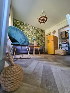 a living room with a chair and a table at Világos Kert Balatonvilágos Chill House in Balatonvilágos