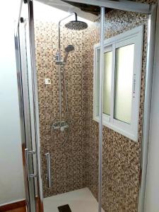 a shower with a glass door in a bathroom at Loft Con Encanto in Frontera